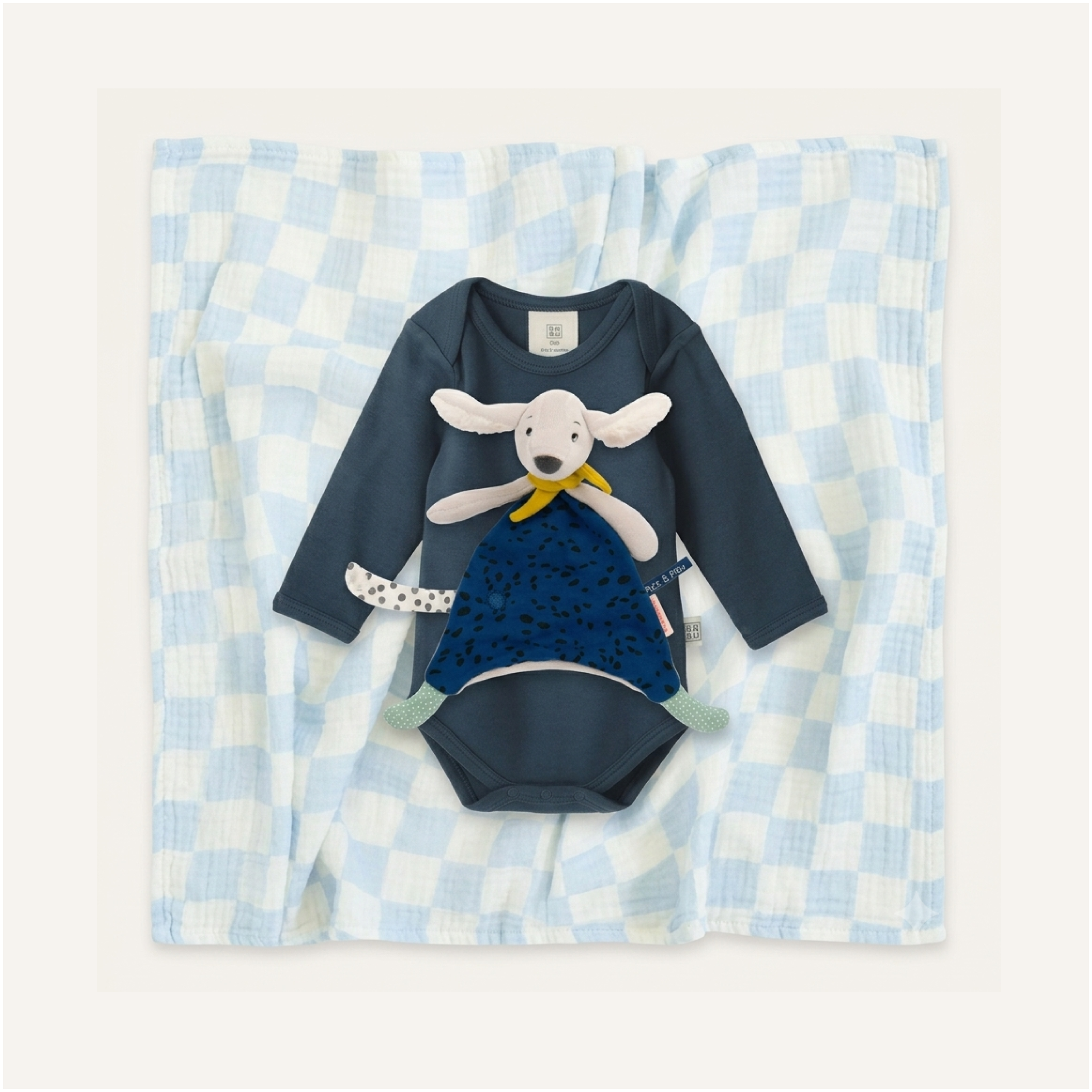Blue Check Snuggle baby clothing Set by Clay and Hutch. Babu, Golden Child and Moulin Roty baby clothing and soft toys. A baby long-sleeve bodysuit in dark navy blue with a Blue Pilou Comforter, Puce & Pilou soft toy.